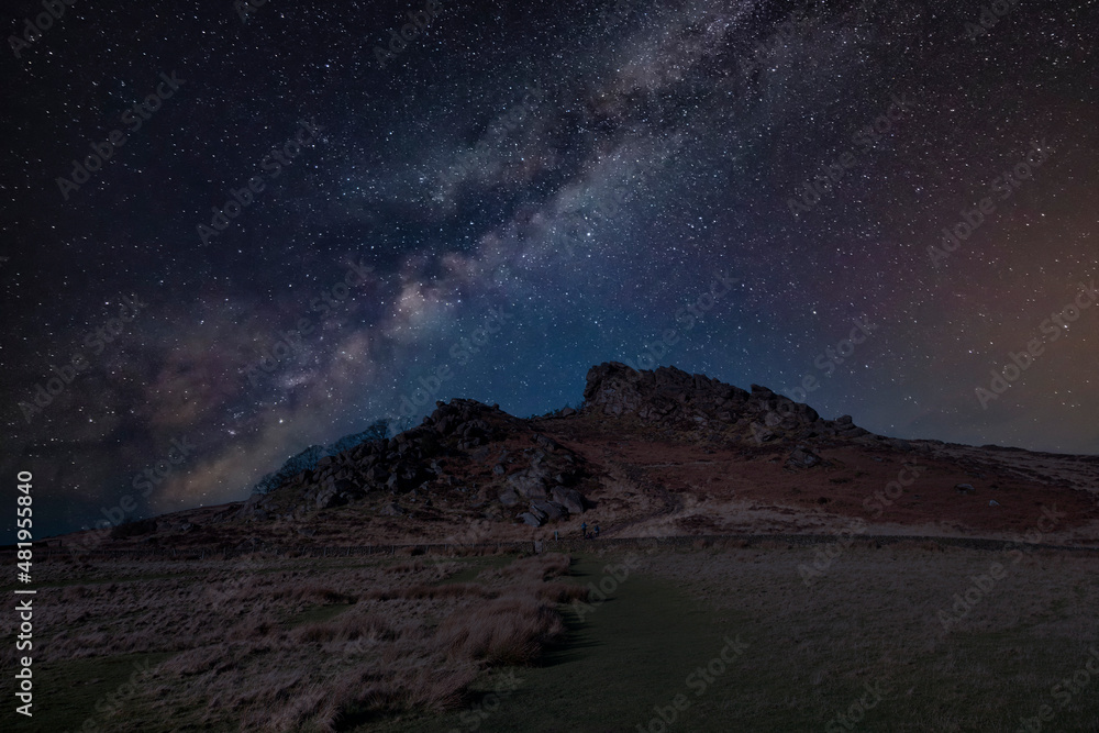 Digital composite image of Milky Way and Epic Epic Peak District Winter landscape of Ramsaw Rocks viewed from Hen Cloud