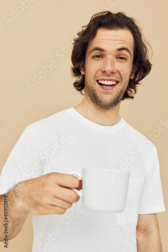 Cheerful man with a white mug in his hands emotions posing isolated background