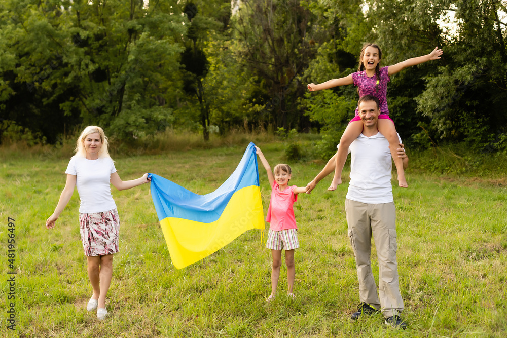 Fototapeta premium Ukraine's Independence Flag Day. Constitution day. family with the flag of ukraine in field. 24 August. Patriotic holiday.