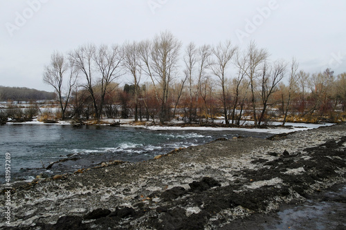 Winter 2022. Islands on the river. Irtysh river. Grunge landscape. Cloudy day. © Lena Philip