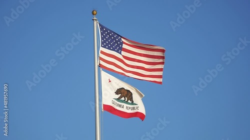 United States flag and california state flag waving in the wind in slow motion 180fps