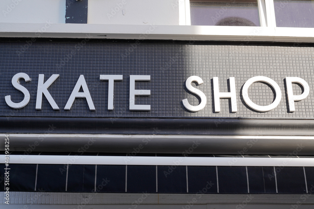 skate shop text sign facade store logo in city street specialized in skateboard