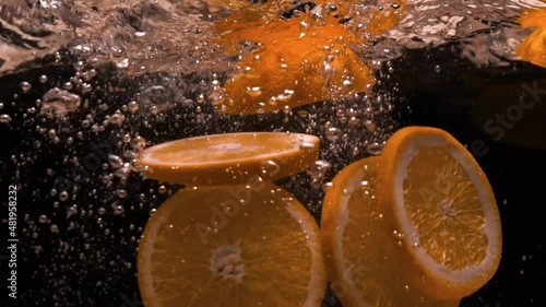 Orange flies into the water. Slow motion