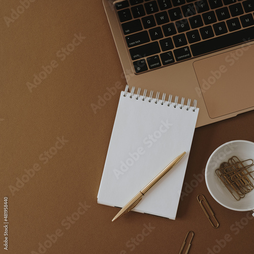 Aesthetic home office desk workspace. Laptop computer  notebook on neutral tan brown table. Influencer lifestyle blog background with copy space