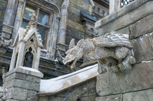 Gargoyle statue attached to the wall of the castle 