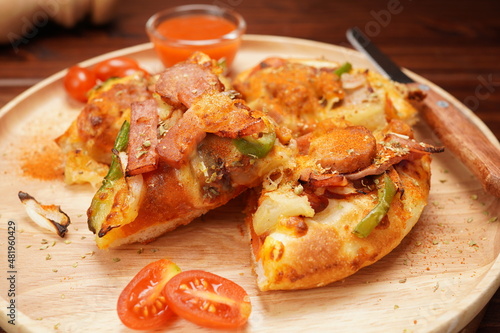 Pizza, vegetables, tomatoes, mushrooms and chili sauce Italian food on a wooden trayPizza, vegetables, tomatoes, mushrooms and chili sauce Italian food on a wooden tray