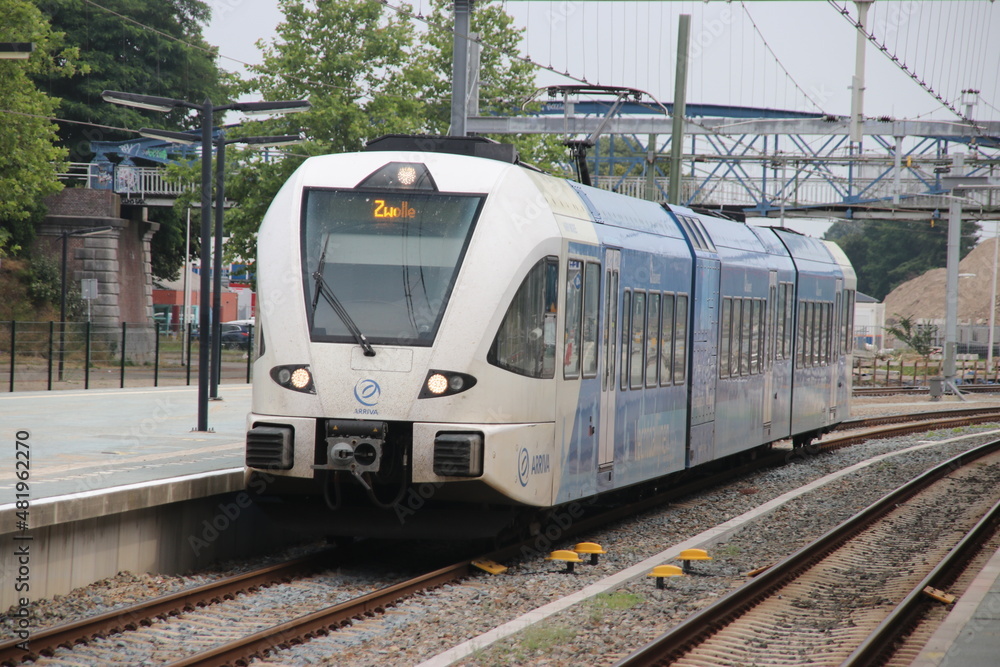 Blue local commuter of NS and local Arriva Stadler train along platform