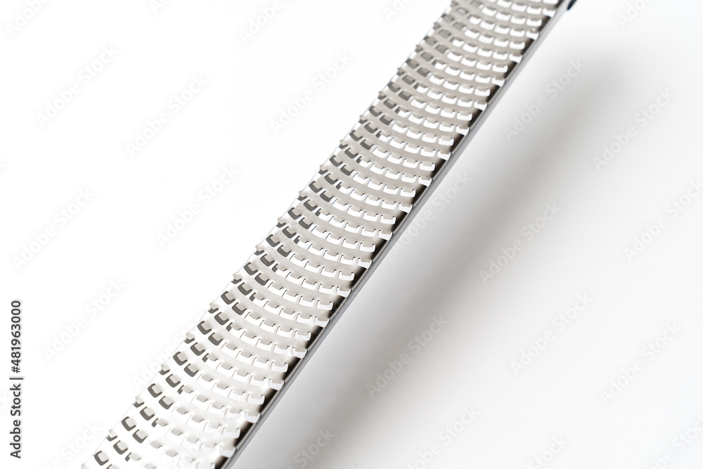part of the grater with a razor-sharp stainless steel blade that does not rust, non-slip handle. Grater for cheese, lemon, ginger, accessories for garlic, kitchen. on a white background. isolate. part of the grater with a razor-sharp stainless steel blade that does not rust, non-slip handle. Grater for cheese, lemon, ginger, accessories for garlic, kitchen. on a white background. isolate.