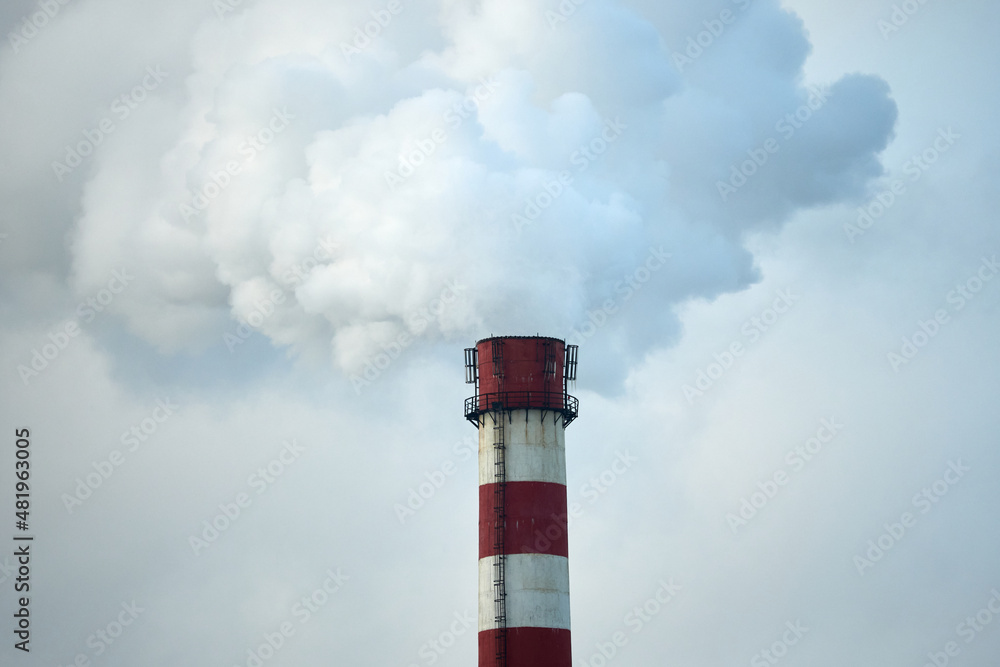Environmental pollution. The tall chimney releases smoke and steam. Environmental pollution. The tall chimney releases smoke and steam.
