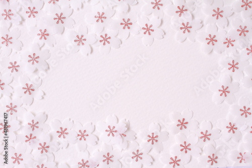 Cherry blossom petal paper crafts on white textured paper background for wall paper. Blank for copy space.