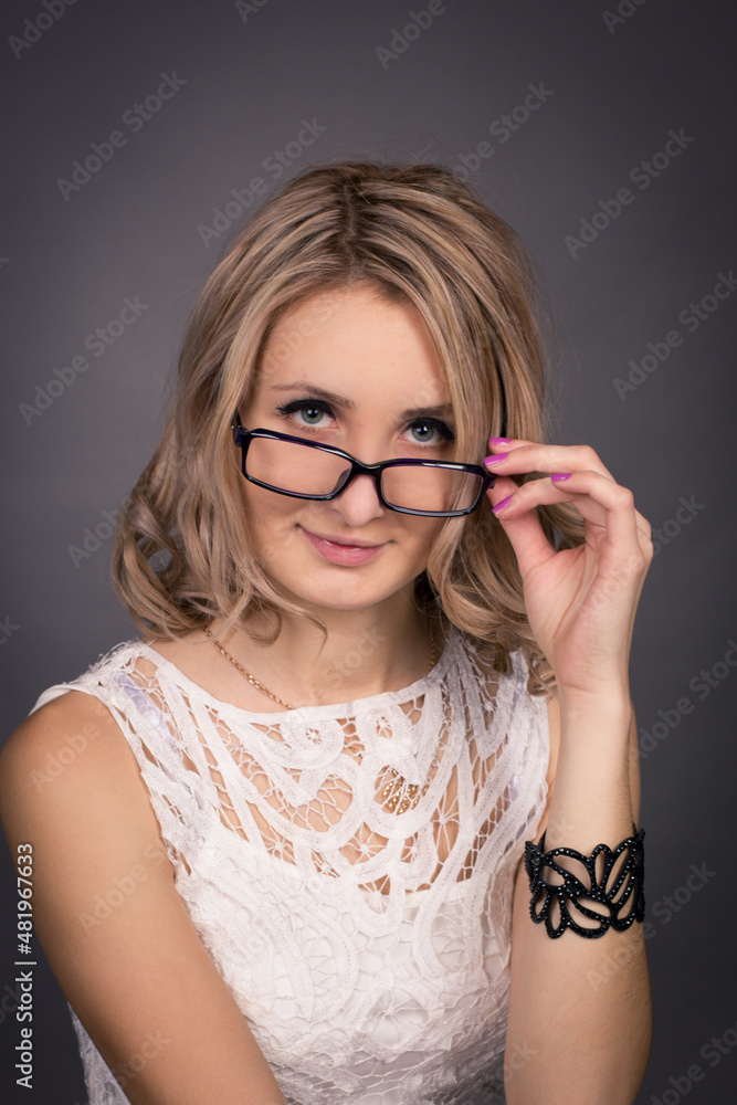 portrait of a young woman with glasses in a photo studio