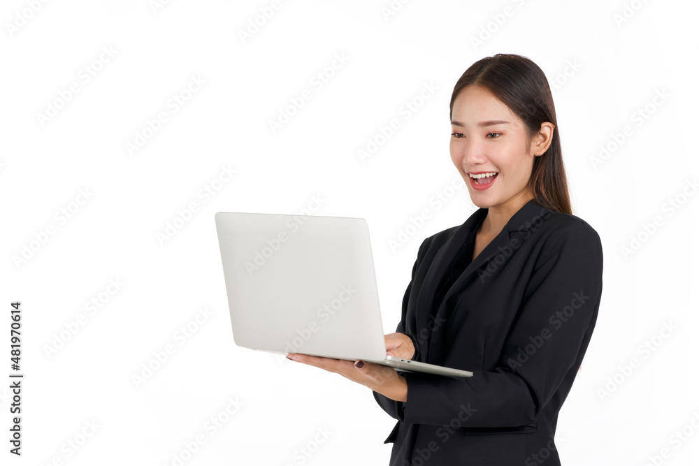 Young asian businesswoman in a black suit looking at laptop computer monitor in her hand. Portrait on white background with studio light. Young asian businesswoman in a black suit looking at laptop computer monitor in her hand. Portrait on white background with studio light.