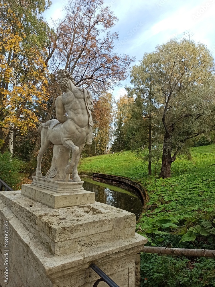 Sculpture of a centaur in an ancient park on a bright autumn day.