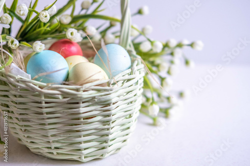 Wallpaper Mural Baskets with Easter colored eggs on a white wooden table surrounded by delicate spring flowers Torontodigital.ca
