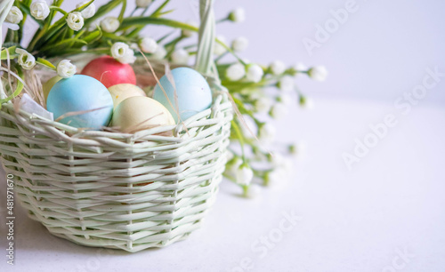 Wallpaper Mural Baskets with Easter colored eggs on a white wooden table surrounded by delicate spring flowers Torontodigital.ca
