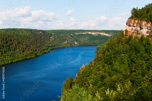 Beautiful river on forest background and blue sky