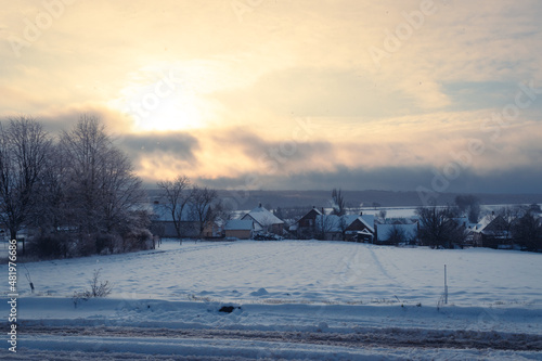 Rural hungarian village covered in snow at sunset