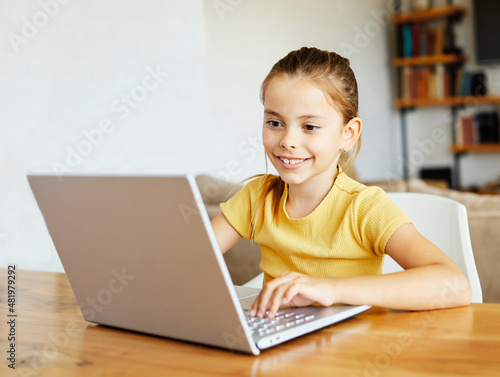 child laptop computer technology home girl education homework kid learning internet childhood student sitting connection using online photo