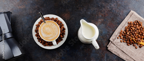 Photos Cup of coffee and coffee beans on a dark background