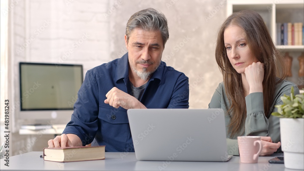 Business people working in office with laptop computer. Happy couple working from home at desk. Talking, meeting, cooperation, entrepreneurs, advisor. Business people working in office with laptop computer. Happy couple working from home at desk. Talking, meeting, cooperation, entrepreneurs, advisor.