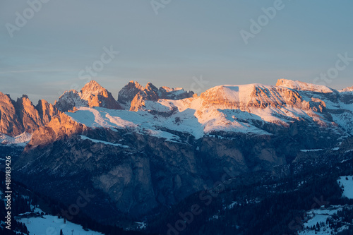 Mountains covered with snow and lit red by the sunset light