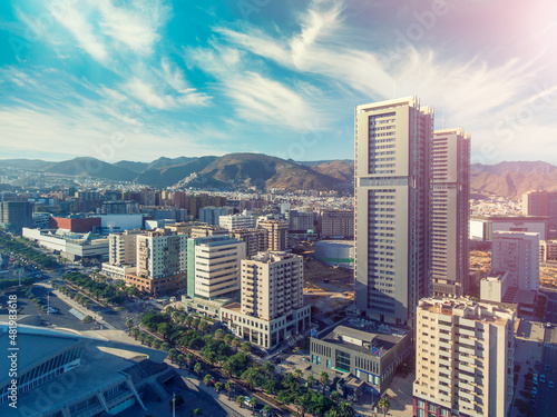 Aerial view of Santa Cruz de Tenerife on a sunny day. Skyscrapers and coastline from drone, Canary Islands.. photo