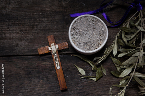 bowl with ashes and olive branch. ash wednesday concept