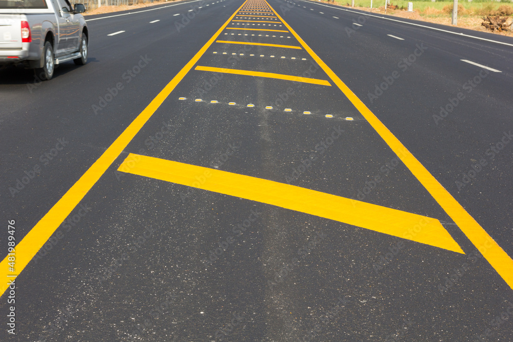 Asphalt road as abstract background, yellow line on the road texture