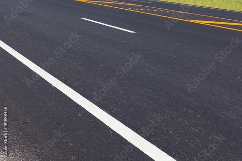 Asphalt road as abstract background, yellow line on the road texture