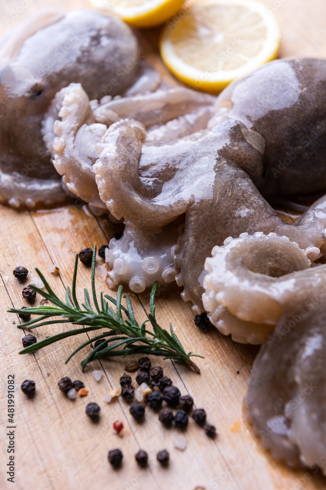 Fototapeta premium Baby octopus with lemon and rosemary. Selective focus