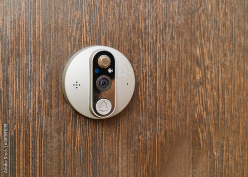 electronic of the peephole with call button or intercom on the front door.  photo