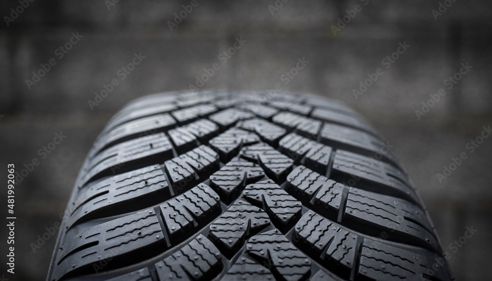 Close-up of the tread of a new winter tyre. Driving safety, road safety and car service concept. Close-up of the tread of a new winter tyre. Driving safety, road safety and car service concept.