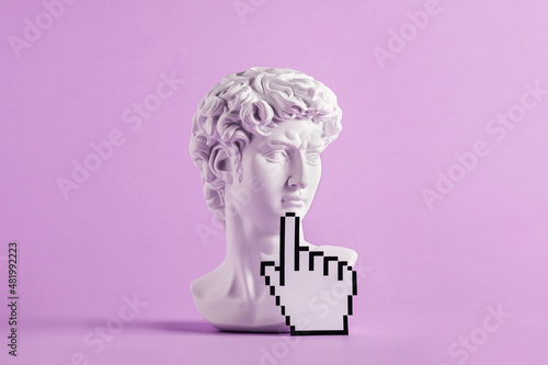 Historical antique statue of david's head and mouse cursor with finger photo