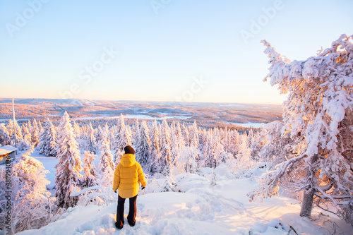 Young woman in winter forest in Finland photo