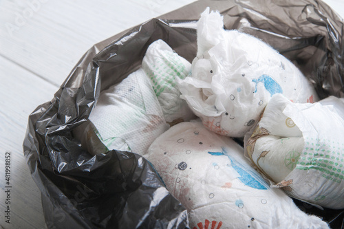 Diapers waste, dirty diapers in trash bag. Disposing of used baby nappies....