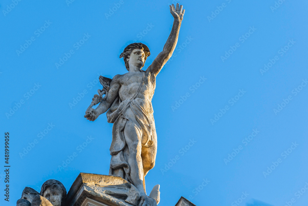 Lviv, Ukraine - January, 2022: statue of Mercury (Hermes) on the roof of an ancient house.