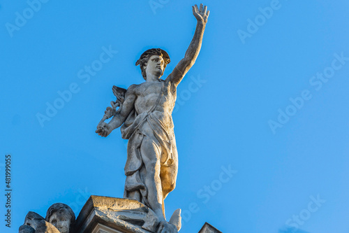 Obraz na płótnie Lviv, Ukraine - January, 2022: statue of Mercury (Hermes) on the roof of an ancient house. w salonie