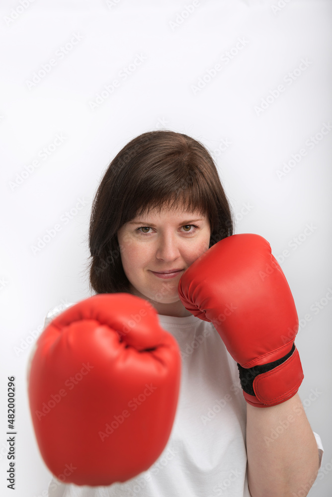 Portrait of confident young woman in boxing gloves. Woman fights for justice. Feminism. Portrait of confident young woman in boxing gloves. Woman fights for justice. Feminism.