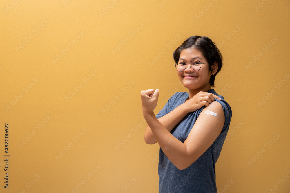 Asian happy girl show confidence and showing her arm with bandage after got vaccinated, teenager immunization, Covid preventive vaccine. Asian happy girl show confidence and showing her arm with bandage after got vaccinated, teenager immunization, Covid preventive vaccine.