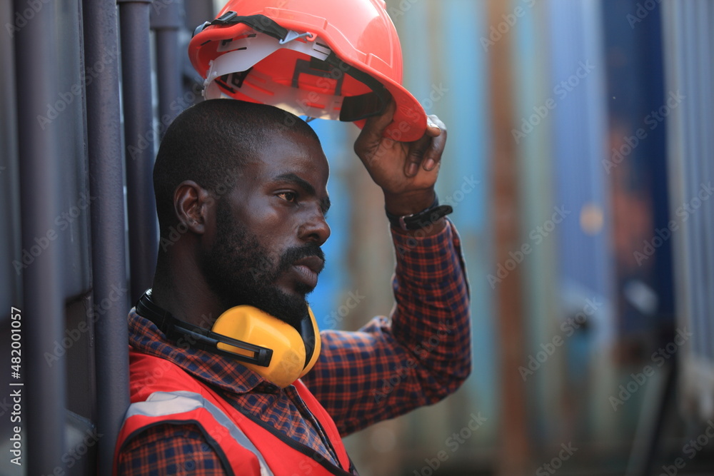 African American handsome black engineer he is working in container box yard area of logistics transportation import export or shipping industry