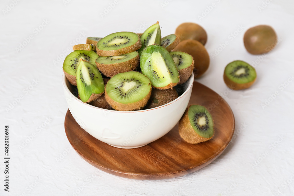 Bowl with fresh cut kiwi on light background, closeup Bowl with fresh cut kiwi on light background, closeup