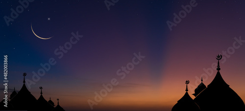 silhouette of dome mosques and crescent moon on dusk sky twilight background  © Nature Peaceful 