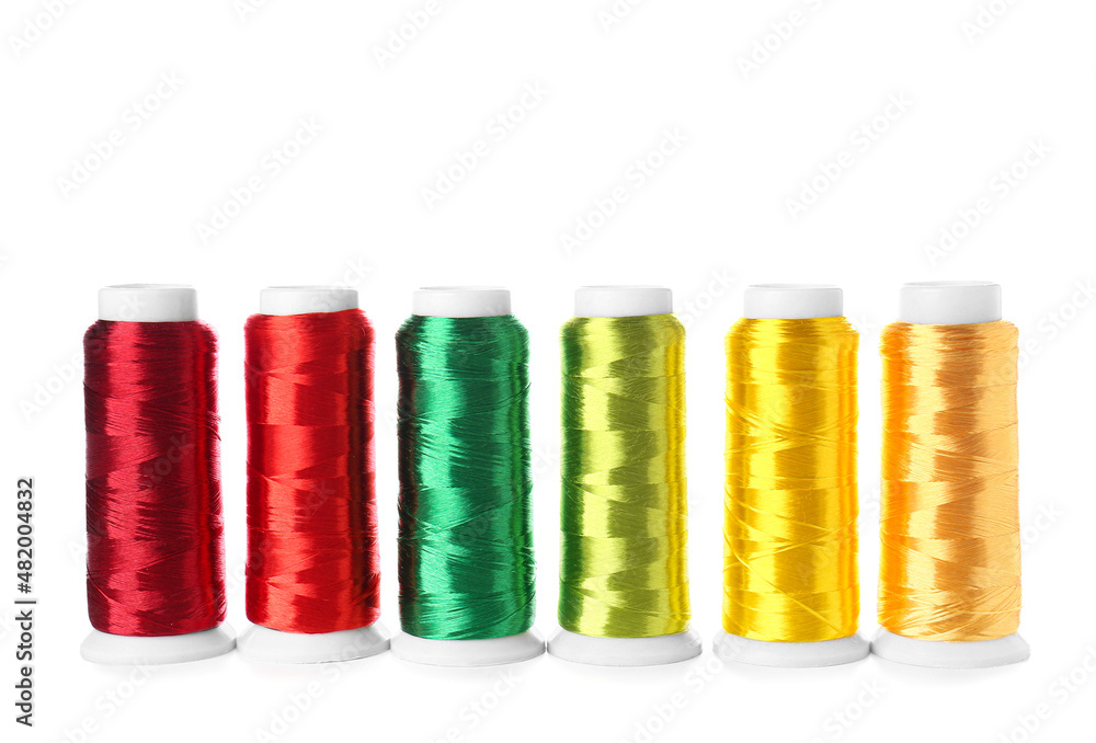 Different sewing thread spools on white background Different sewing thread spools on white background