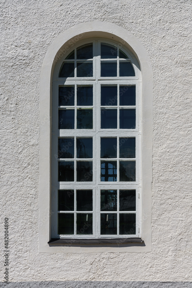 Large vaulted window on a white wall