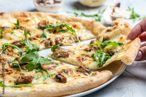 pizza with pear, blue cheese, walnut and arugula on light background. banner, menu, recipe place for text, top view
