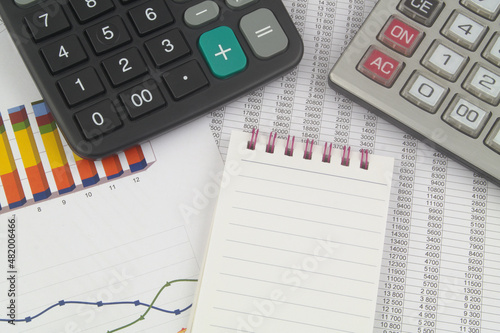 Business, financial data and counting concept. Calculators and notebook on financial documents.