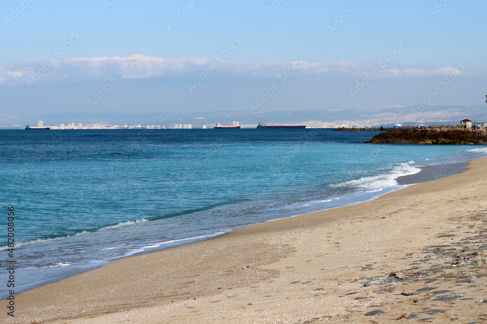 Golden sand, blue sea, calm water. Beautiful seascape. 