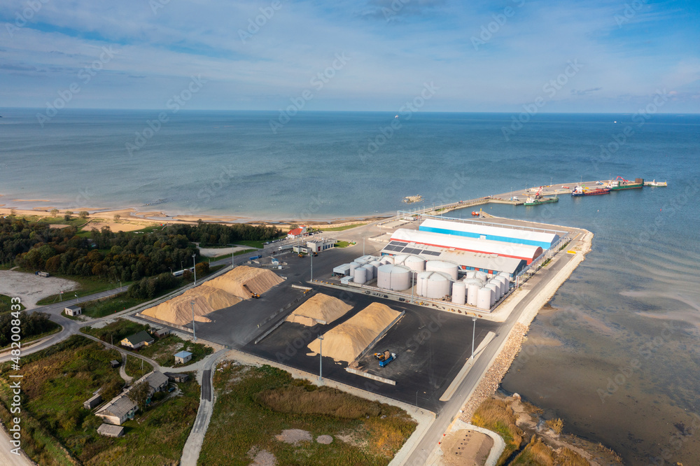 An aerial drone view of the industrial port in the Baltic Sea. Storage areas and tank fleet of the liquid chemicals terminal.	