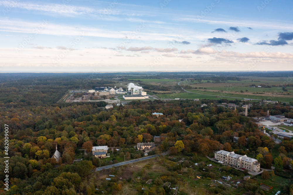 Fototapeta premium An aerial drone view of the industrial city in the Baltic. Plant for the production of concrete. Wind park.