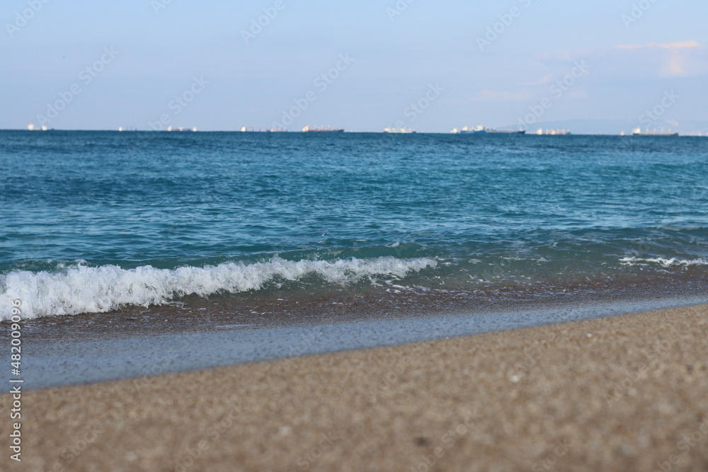 Golden sand, blue sea, calm water. Beautiful seascape. 